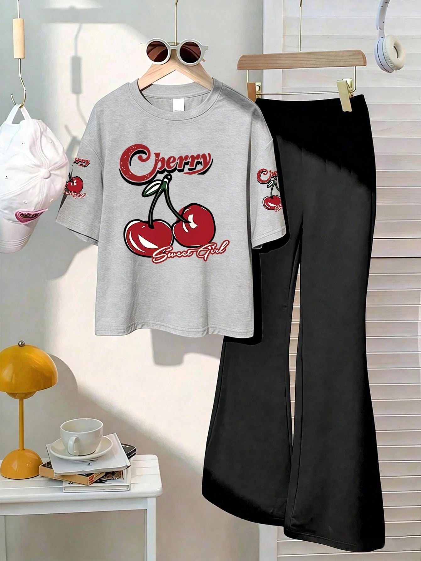 This Casual Girls' Set Includes A Round Neck T-Shirt With Cherry Print And Black Flare Pants. Whether For School, Shopping, Street Style, Or Vacation, It Is An Excellent Choice. Grey